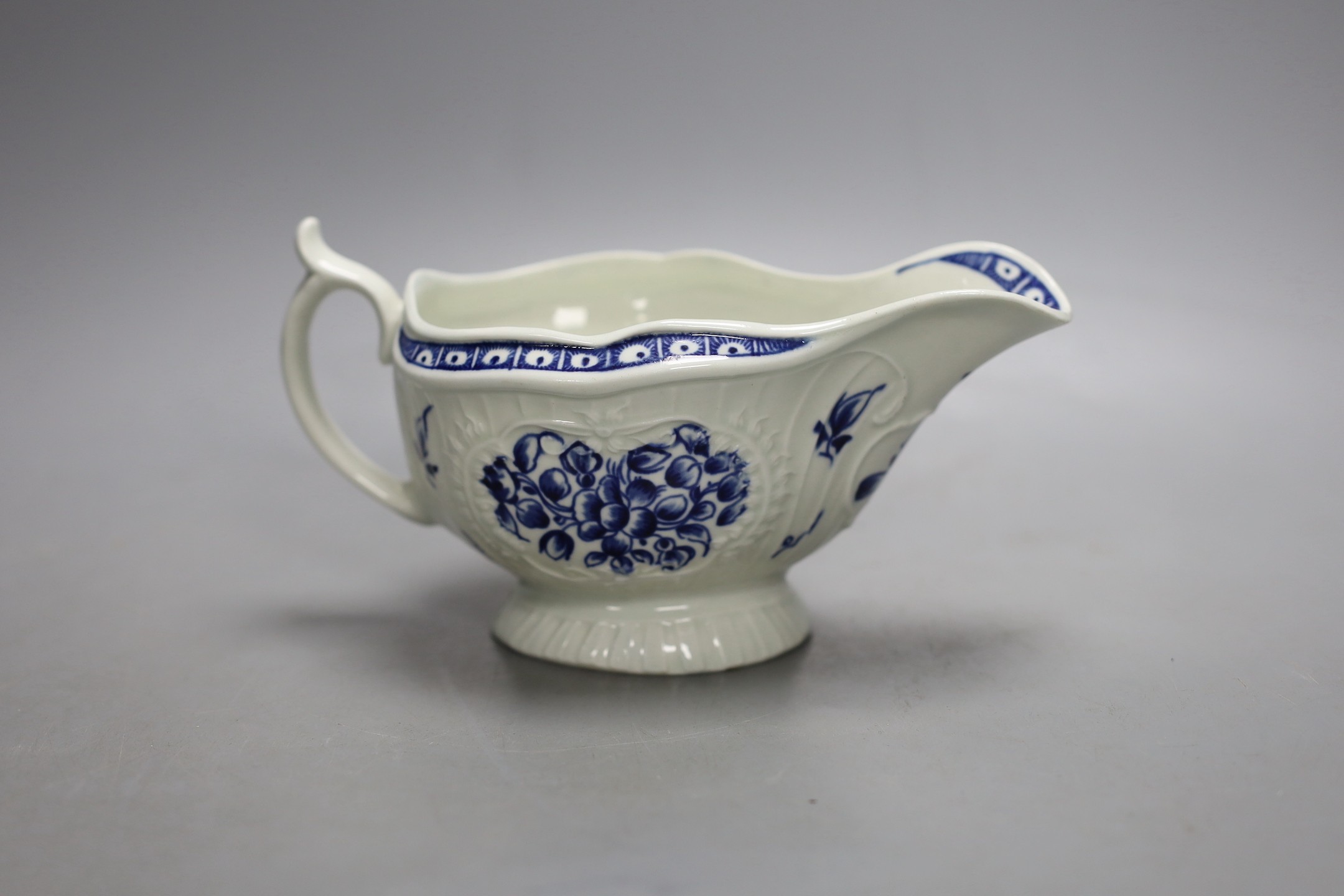 A Worcester sauceboat painted with the Strap Fluted Floral pattern c. 1768-72, 16.5 cms wide.